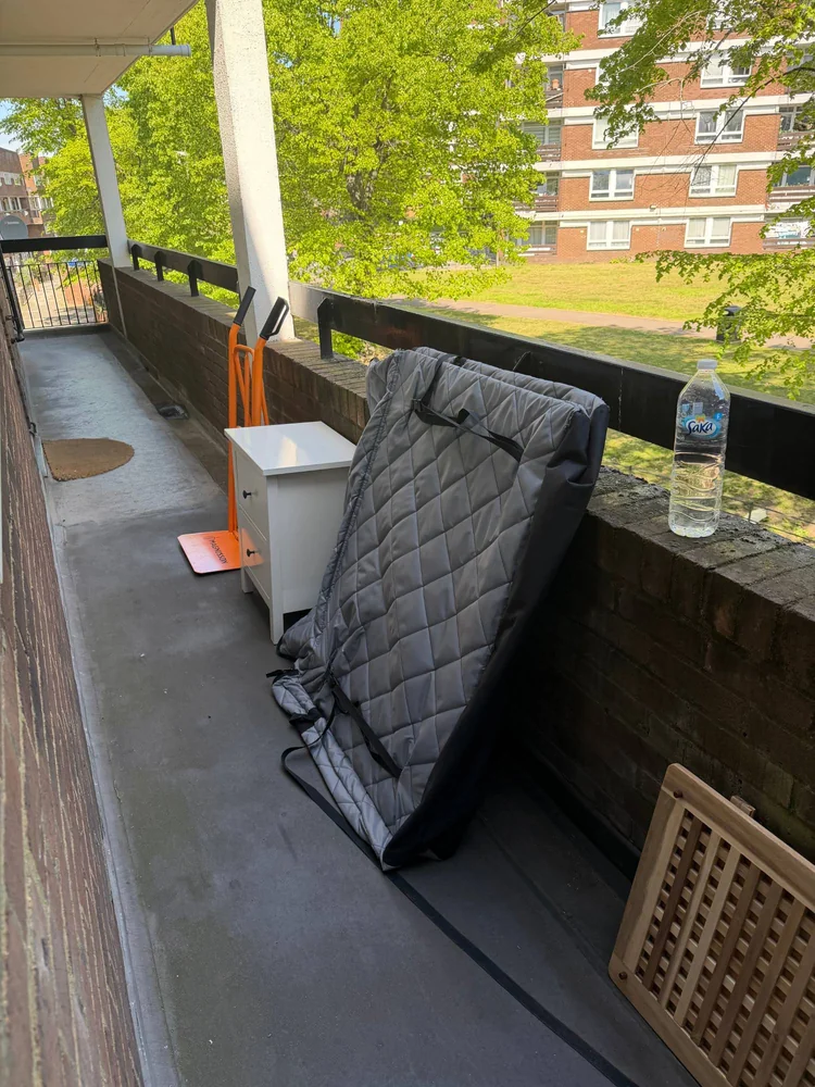 Sack truck and furniture covers set up for a flat clearance