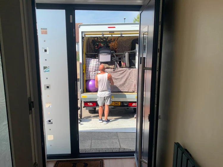 Gym equipment loaded onto the removals van from the front door