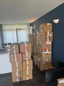 Boxes marked fragile packed in an open-plan living room ready to move