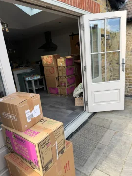 Packed moving boxes in a kitchen ready to be carried out to the removals van