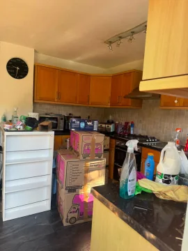 Moving boxes packed and stacked in a kitchen ready for collection
