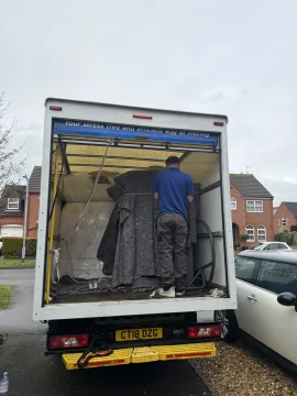 SJC Movers loading furniture into the back of the van