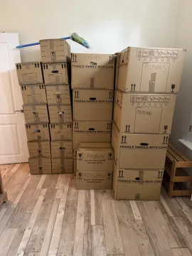 Packed boxes stacked in a living room before the move