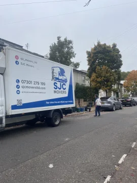 SJC Movers van parked on a South London street