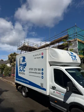 SJC Movers removals van parked outside a house in Carshalton