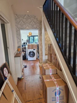 Packed boxes lined up in a hallway on moving day