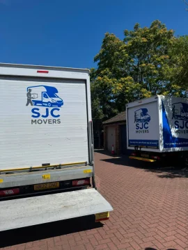 Two SJC Movers vans with tail lifts down for a larger house move