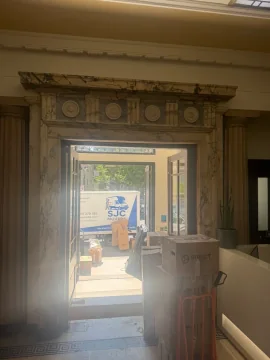 SJC Movers van seen from an office building lobby during a commercial move