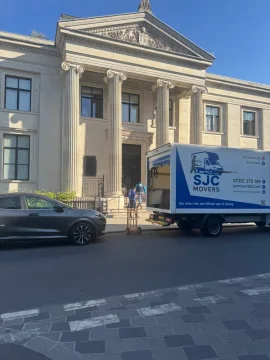 SJC Movers van outside a London office building during an office relocation