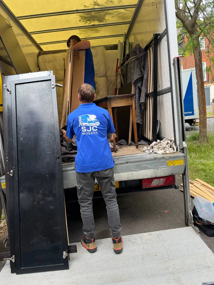Bulky furniture loaded onto the van tail lift for a specialist move in Sutton