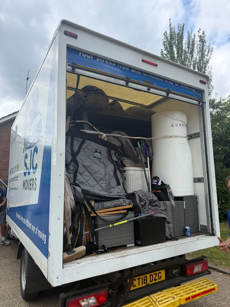 Blanket-wrapped items secured inside the van before transport